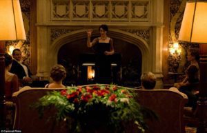 Downton Abbey screenshot of woman in front of a fireplace